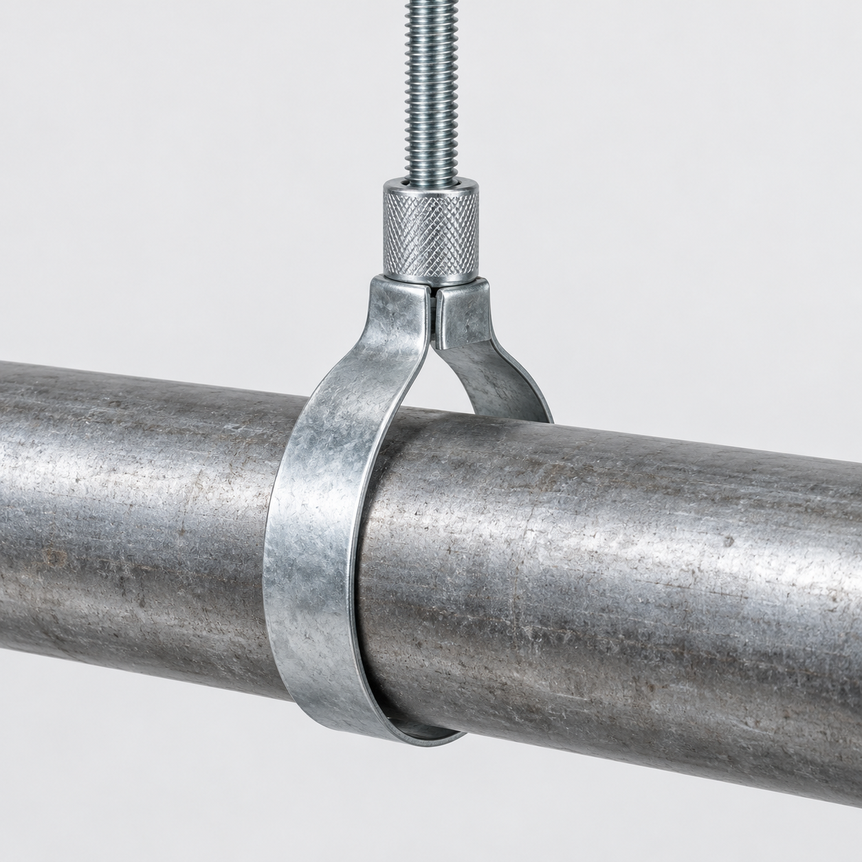 Adjustable Swivel Loop Hanger - Generated Representative Generated representative adjustable swivel loop hanger with one formed metal band, captured top insert nut, threaded rod, and horizontal bare pipe